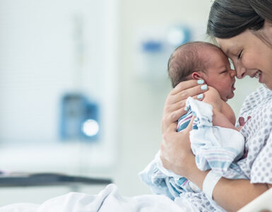 A mother with her newborn baby after childbirth with a midwife and doula.