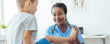 A doctor working with her young CRMO (Chronic Recurrent Multifocal Osteomyelitis) patient.