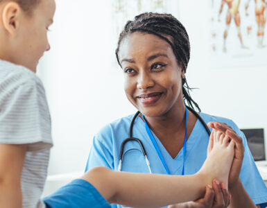 A doctor working with her young CRMO (Chronic Recurrent Multifocal Osteomyelitis) patient.