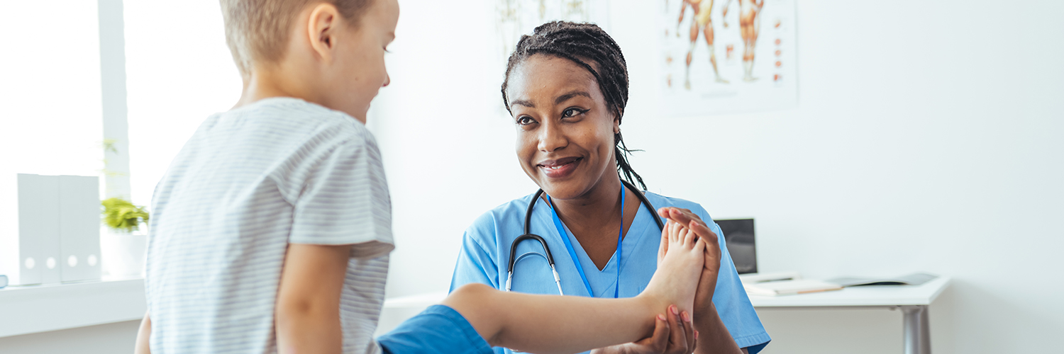 A doctor working with her young CRMO (Chronic Recurrent Multifocal Osteomyelitis) patient.