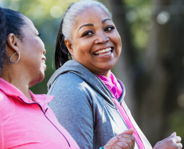 Two women exercising outdoors, losing weight to fight diabetes.