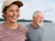 An older woman and man getting exercise on the beach.