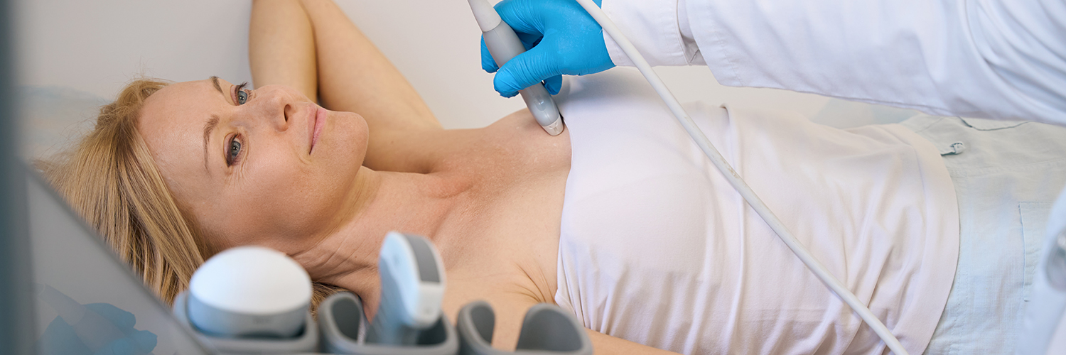 A woman with dense breasts being screened for breast cancer with an ultrasound.