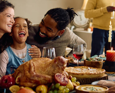 A family gathered at the dining room table celebrating the holidays together.