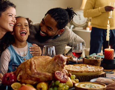 A family gathered at the dining room table celebrating the holidays together.