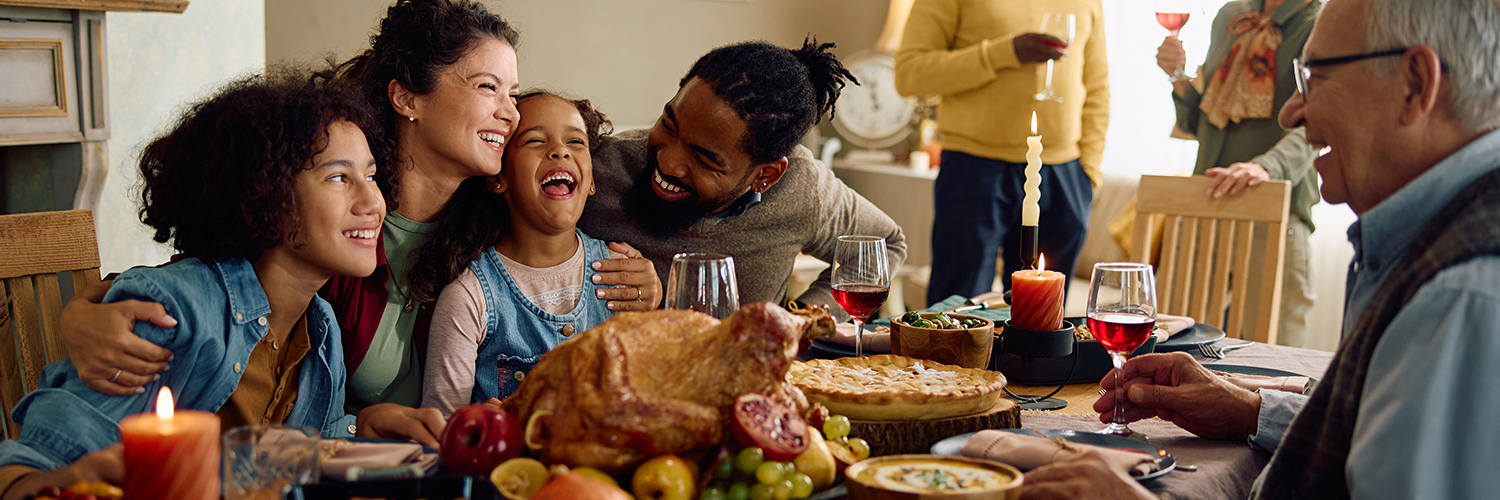 A family gathered at the dining room table celebrating the holidays together.