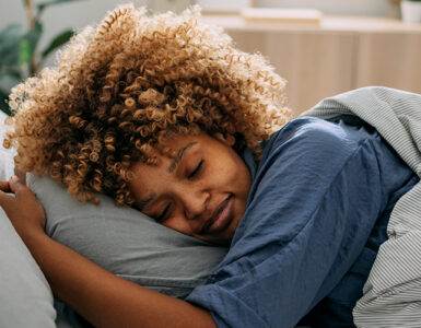 A woman deep sleeping peacefully in her bed.