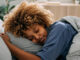 A woman deep sleeping peacefully in her bed.