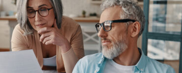 A husband and wife looking over the best prostate cancer treatments available in early stages.