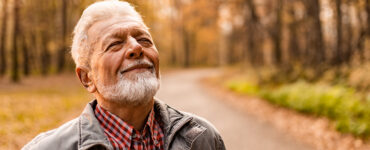 A man taking a walk alone, finding healthy ways to cope with his grief and strong emotions.