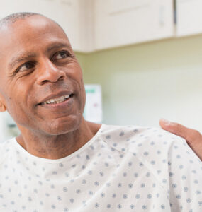 A man at his doctor's office discussing his lung cancer screening.