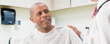 A man at his doctor's office discussing his lung cancer screening.