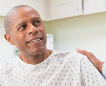 A man at his doctor's office discussing his lung cancer screening.