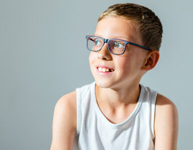 A boy sitting in a doctor's office, being evaluated for a Tourette Syndrome diagnosis.