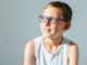 A boy sitting in a doctor's office, being evaluated for a Tourette Syndrome diagnosis.