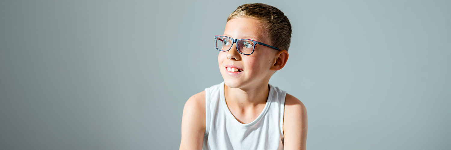 A boy sitting in a doctor's office, being evaluated for a Tourette Syndrome diagnosis.