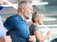 A group of older adults exercising on treadmills next to one another, as part of their cardiac rehab program.