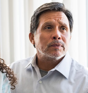 A father and daughter sitting at the doctor's office, discussing Tourette Syndrome.