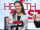 Three leaders from Stony Brook Medicine holding up their mugs in the podcast recording studio.