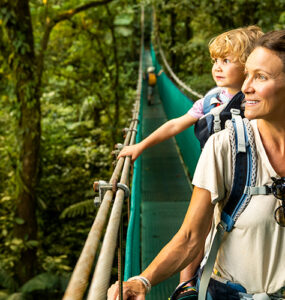 A mother and her young son in a canoe, sightseeing while traveling overseas.