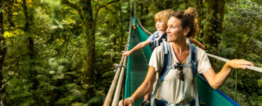 A mother and her young son in a canoe, sightseeing while traveling overseas.