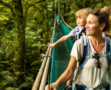 A mother and her young son in a canoe, sightseeing while traveling overseas.