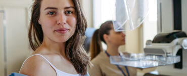 A woman in an outpatient medical office, having a mammography for breast cancer screening.