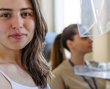 A woman in an outpatient medical office, having a mammography for breast cancer screening.