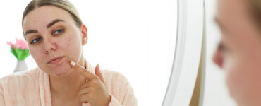 women looking in the mirror at her chin