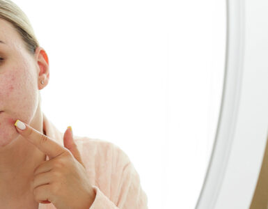 women looking in the mirror at her chin