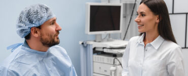 A man in his 40s prepping with his doctor in the medical room before getting a colonoscopy.