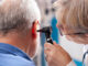 A doctor checking older man's hearing