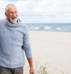 older couple walking on the beach