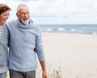 older couple walking on the beach