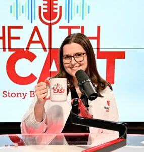 Three physicians from Stony Brook Medicine sitting in the podcast video, holding up coffee mugs and smiling.