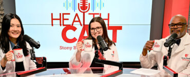Three physicians from Stony Brook Medicine sitting in the podcast video, holding up coffee mugs and smiling.