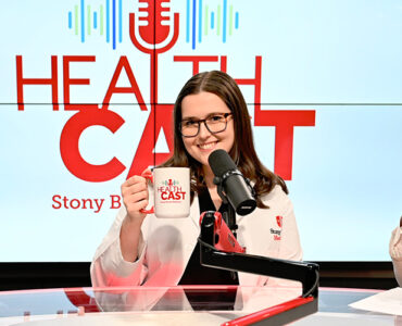 Three physicians from Stony Brook Medicine sitting in the podcast video, holding up coffee mugs and smiling.