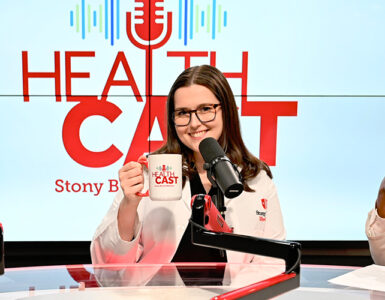 Three physicians from Stony Brook Medicine sitting in the podcast video, holding up coffee mugs and smiling.