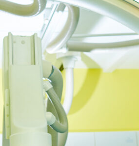 Interventional radiologist looking at computer with imaging scans