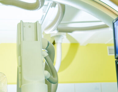 Interventional radiologist looking at computer with imaging scans