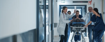 sepsis patient on gurney in hospital with ER doctors