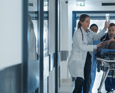 sepsis patient on gurney in hospital with ER doctors