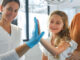 Little girl in emergency department with her mom.