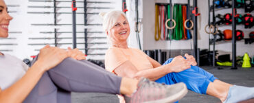 Senior woman workout with trainer at the gym