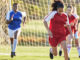 Sports team, girl soccer and kick ball on field in a tournament.