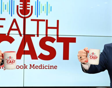 Experts from Stony Brook Medicine sitting in the podcast studio, holding up coffee mugs and smiling.