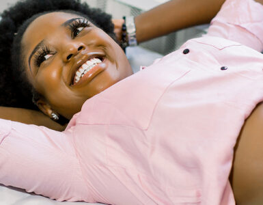 Happy smiling pregnant African American woman getting ultrasound from doctor at her prenatal appointment.