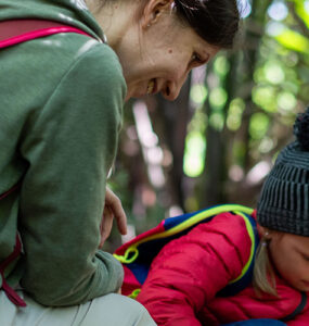 family hiking in the woods stopped to inspect something.