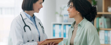 Female doctor with woman for diagnosis.