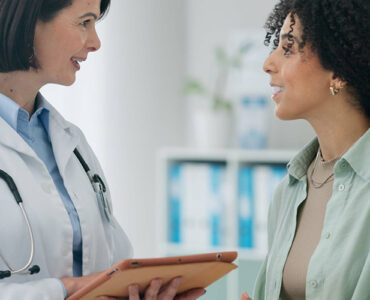 Female doctor with woman for diagnosis.